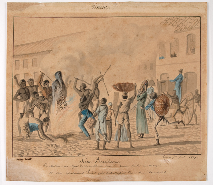 This image is a painting. Title: Scéne Brésilienne (Brazilian Scene). 1818. Artist Aimé-Adrien Taunay. Medium and support: Watercolor on paper. This painting represents the burning of Judas. There are eight characters around a bonfire with the Judas doll burning in the middle. There are around nine other characters watching the celebration from a distance. Three of them carry baskets while the other three look like guards, according to their clothing. Big colonial houses emerge in the background. Some of the characters have some details on clothes and baskets painted in blue and Orange. All characters except the guards are black. There is a thin frame around the painting with the title and a brief description of the scene in french under it. The names of the engraver and artist are at the frame’s right and left corners.
